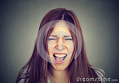 Headshot of an annoyed angry woman screaming. Stock Photo