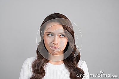 Headshot of indecisive confused young girl. emotional girl isolated on white background Stock Photo