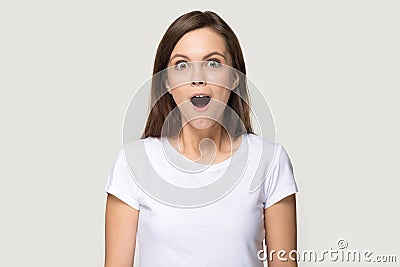 Headshot of millennial woman sincerely surprised looking at camera Stock Photo