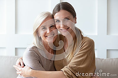 Headshot portrait of mature mom and adult daughter posing Stock Photo