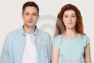 Headshot portrait millennial serious girl and guy isolated on grey Stock Photo