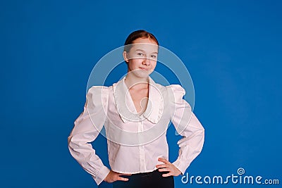 headshot smiling teenager girl in white shirt looking at camera isolated light blue studio background Stock Photo