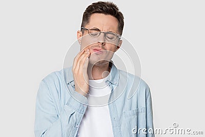 Headshot studio portrait man in glasses suffers from tooth ache Stock Photo