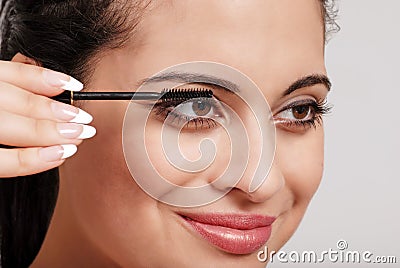 Headshot woman applying mascara Stock Photo