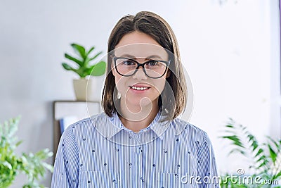 Headshot young smiling woman looking at camera in home interior Stock Photo