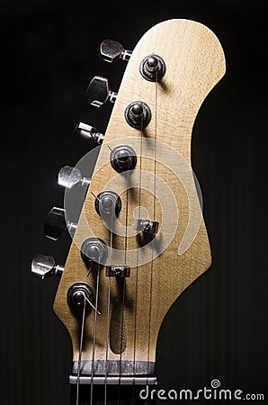 Headstock of an electric guitar on a dark background Stock Photo