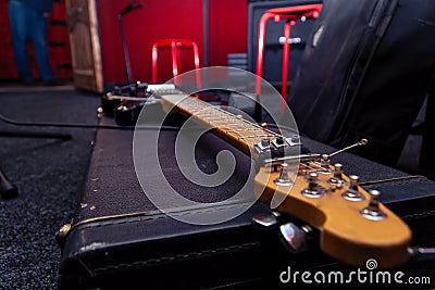 Headstock with tuning pegs electric guitar on a hard black case Stock Photo
