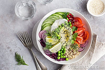 Healhty vegan lunch bowl. Avocado, quinoa, tomato, cucumber, red Stock Photo