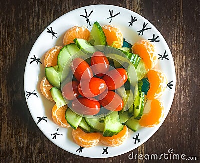 Healhy plate with mandarin cucumber and tomatoes Stock Photo