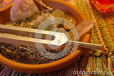 Healing tuning fork and crystal stone on table . Stock Photo