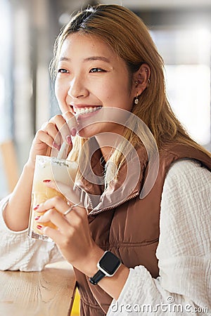 Health, Asian woman and smoothie for diet, in a cafe and happiness for wellness and thinking. Japan, female and happy Stock Photo