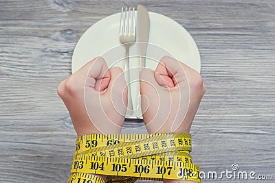 Health body care unhealthy eating dieting starving weight loss slimming. Concept of bad food habbits and unhealthy eating. Woman` Stock Photo