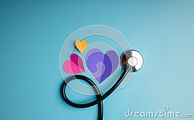 Health Care Concept. International World Heart Day. Paper Cut as Heart Shape with Stethoscope lay on Blue background Stock Photo