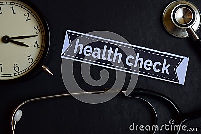 Health Check on the print paper with Healthcare Concept Inspiration. alarm clock, Black stethoscope. Stock Photo