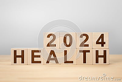 2024 health concept. wooden cube change year 2023 to 2024. gray background, copy space. wooden cube change on desk. gray Stock Photo