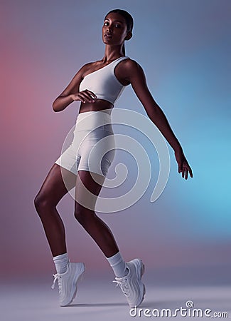 Health, fitness and sports fashion of woman on a studio background ready for workout for exercise. Strong, working out Stock Photo