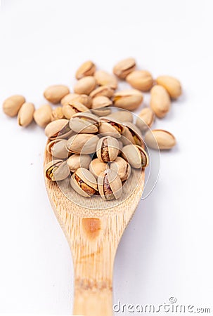 Health Food Pistachios on a Wooden Spoon Stock Photo