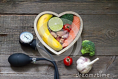 Health heart diet food concept with blood pressure gauge Stock Photo