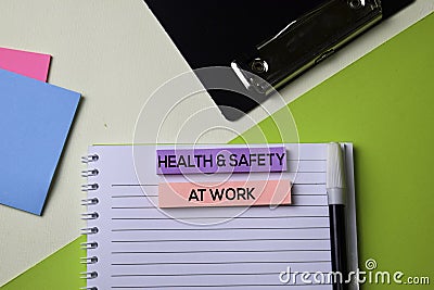 Health & Safety at Work text on top view office desk table of Business workplace and business objects Stock Photo