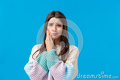 Health, stomatology concept. Silly cute woman in winter sweater, complaining on toothache, having decay or rotten tooth Stock Photo