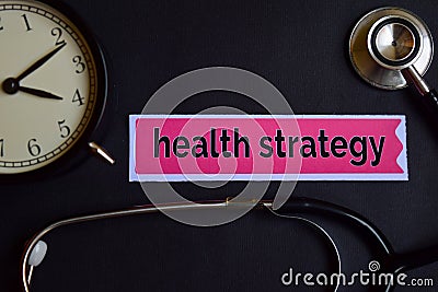 Health Strategy on the print paper with Healthcare Concept Inspiration. alarm clock, Black stethoscope. Stock Photo