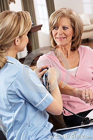 Health Visitor Taking Woman's Blood Pressure Stock Photo