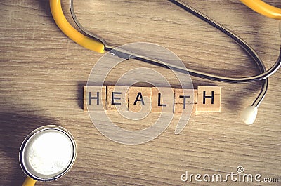 Health word background on wood blocks with yellow stethoscop on wood background , top view ,healthy concept Stock Photo