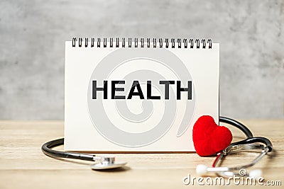 Health word on notebook and stethoscope on table. healthcare, Insurance, Wellness and medical concept Stock Photo