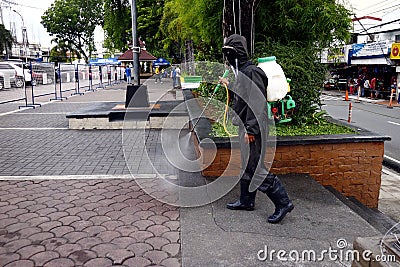 Health worker spray disinfectant around a public park during the Covid 19 virus outbreak Editorial Stock Photo