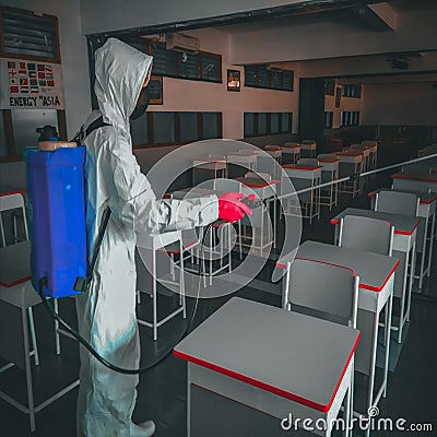 a health worker is spraying disinfectant at a school in Jakarta Editorial Stock Photo