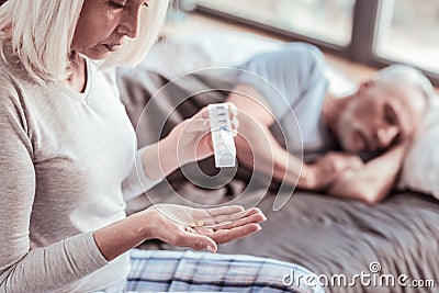 Close up of elderly woman with pills Stock Photo