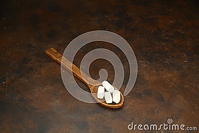 Healthcare concept of ladle with spoon of various medicine tablet, caplets, pills, capsule on rusty background Stock Photo