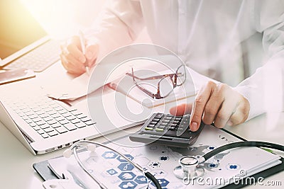 Healthcare costs and fees concept.Hand of smart doctor used a ca Stock Photo