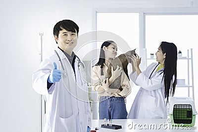 Healthcare and medical concept. Male doctor showing thumbs up. The veterinarian holds an excellent thumb. The vet is checking the Stock Photo