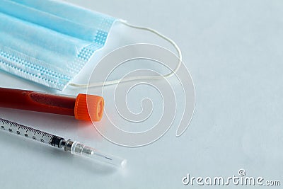 Medical protective mask, syringe, test tubes with blood Stock Photo