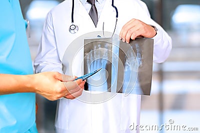 Healthcare, medical and radiology concept - Male doctors looking at x-ray of foot Stock Photo