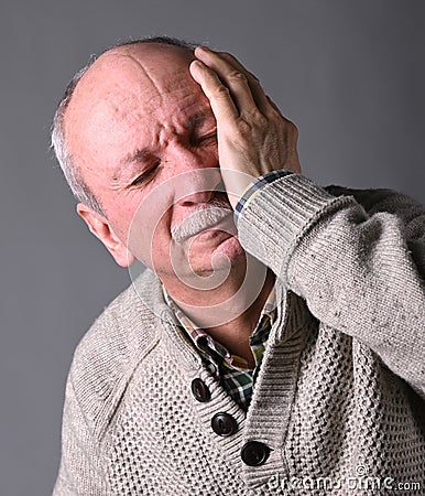 Healthcare, pain, stress and age concept. Sick old man. Senior man suffering from headache Stock Photo