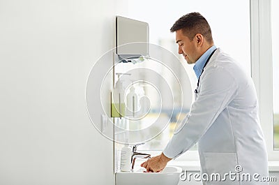 Doctor washing hands at medical clinic sink Stock Photo