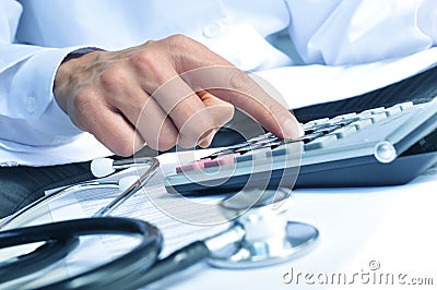 Healthcare professional calculating on an electronic calculator Stock Photo