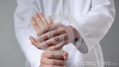 Healthcare specialist examining injured wrist, alternative medicine treatment Stock Photo