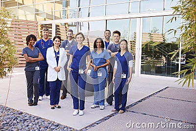Healthcare team with ID badges stand outdoors, full length Stock Photo