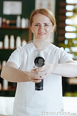 happy massage therapist woman in massage cabinet Stock Photo