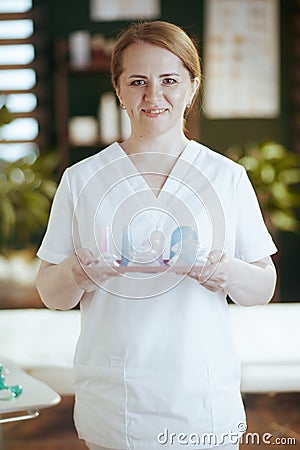 happy massage therapist woman in massage cabinet Stock Photo