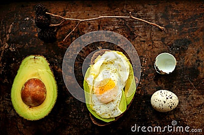 Healthy, alkaline breakfast with avocado sandwich and quail eggs on a grunge background Stock Photo