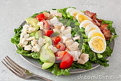 Healthy American Cobb salad with egg bacon avocado chicken tomato. hearty keto low carb diet Stock Photo