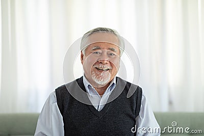 Healthy Asian Elderly man with white hairs smile so happiness and cheerful at home,Portrait of senior man enjoying retirement at Stock Photo