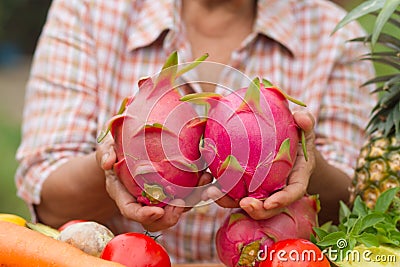 Healthy auntie or senior woman holding tropical fruit Stock Photo