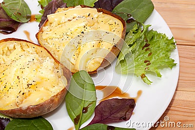 Healthy baked potato with low fat flamed cheese and baby leaf sa Stock Photo