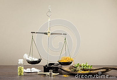 Healthy balance between herbal medicine and pharmaceutical drugs concept. Stock Photo