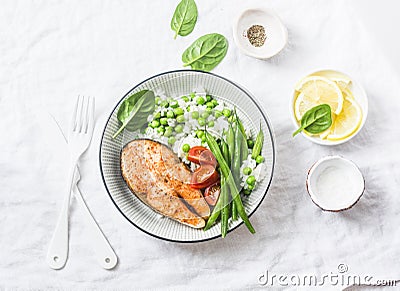 Healthy balanced meal lunch plate - baked salmon with rice and vegetables on a light background Stock Photo